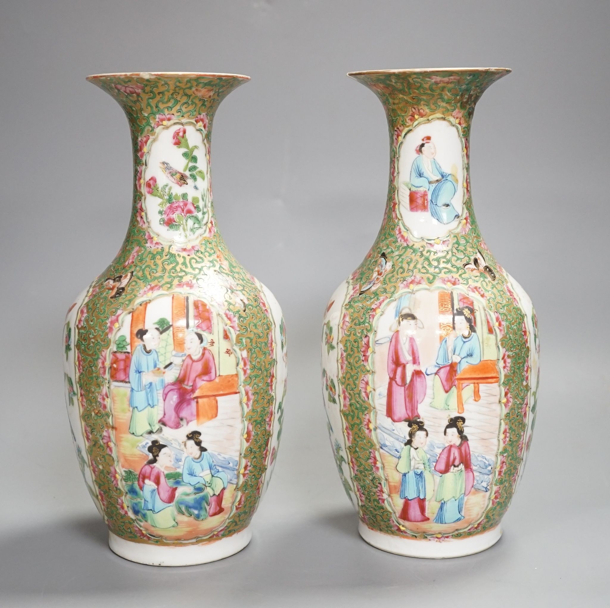 A pair of 19th century Chinese famille rose vases, 24 cms high.